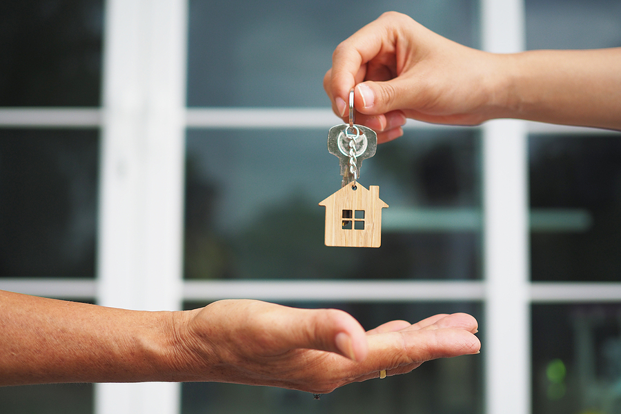 home buyer taking keys to a house